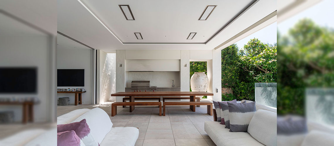 Four Electric Patio Heaters Hanging Over Patio Dining Space